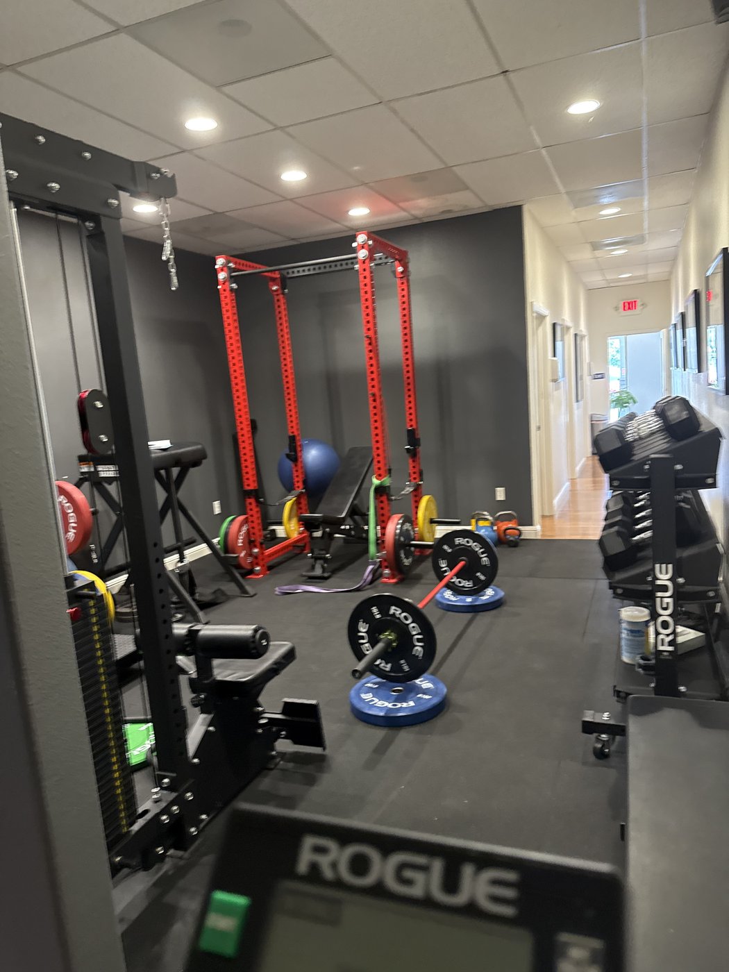 Rogue power rack and bumper plates in VAL Chiropractic rehabilitation gym