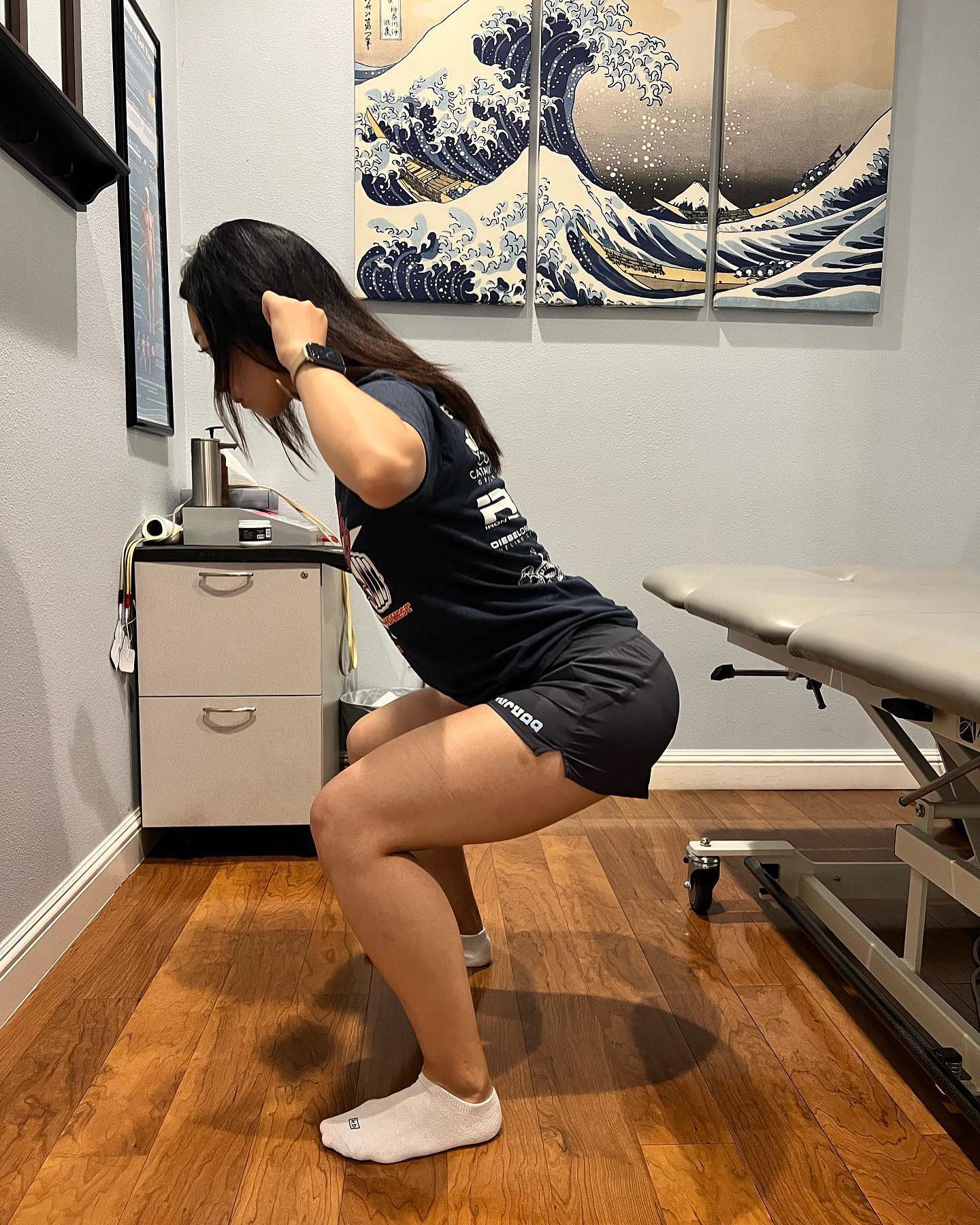 Patient performing a squat during a movement assessment at VAL Chiropractic
