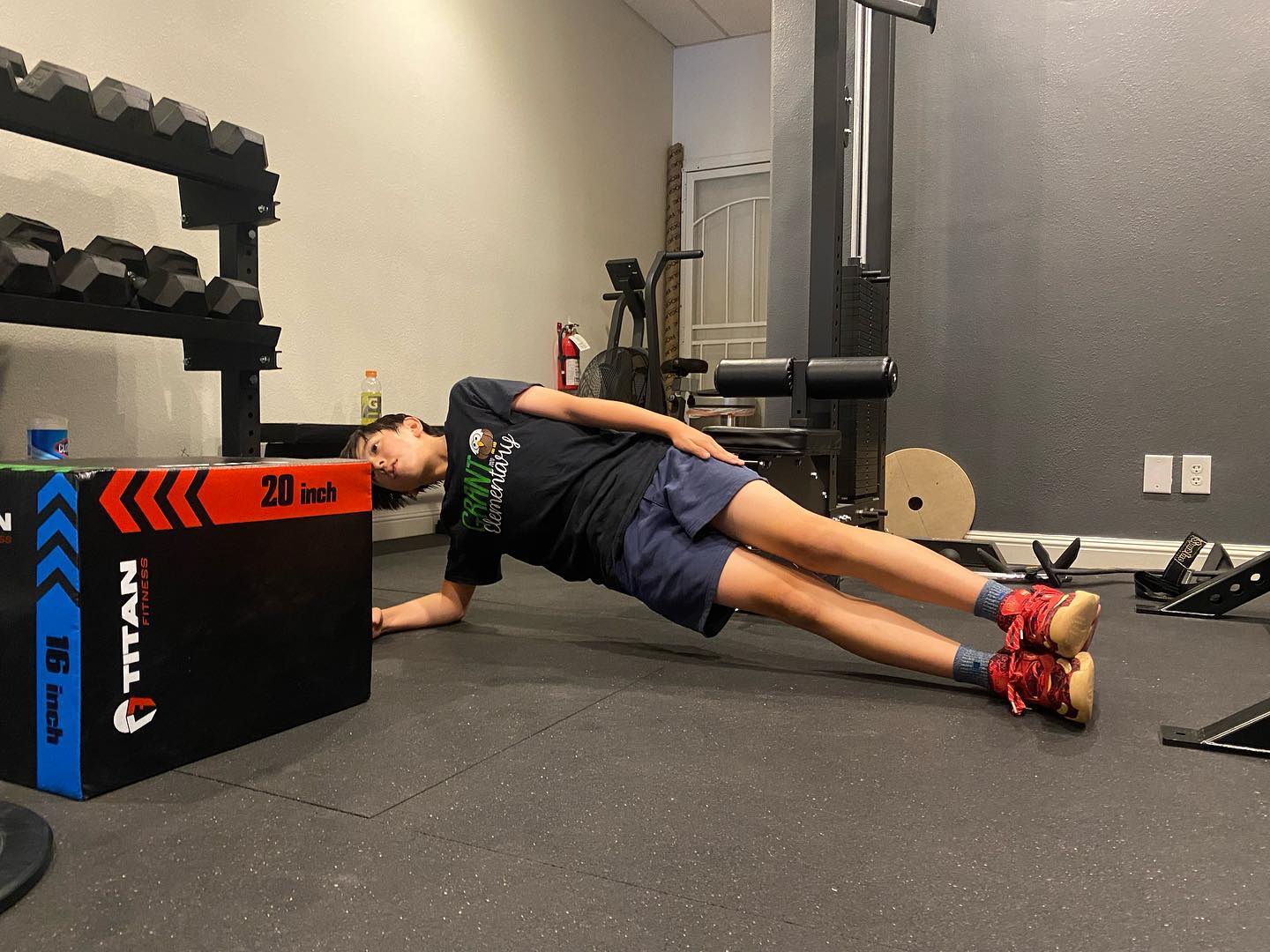 Patient performing a supported side plank in the VAL Chiropractic rehabilitation gym